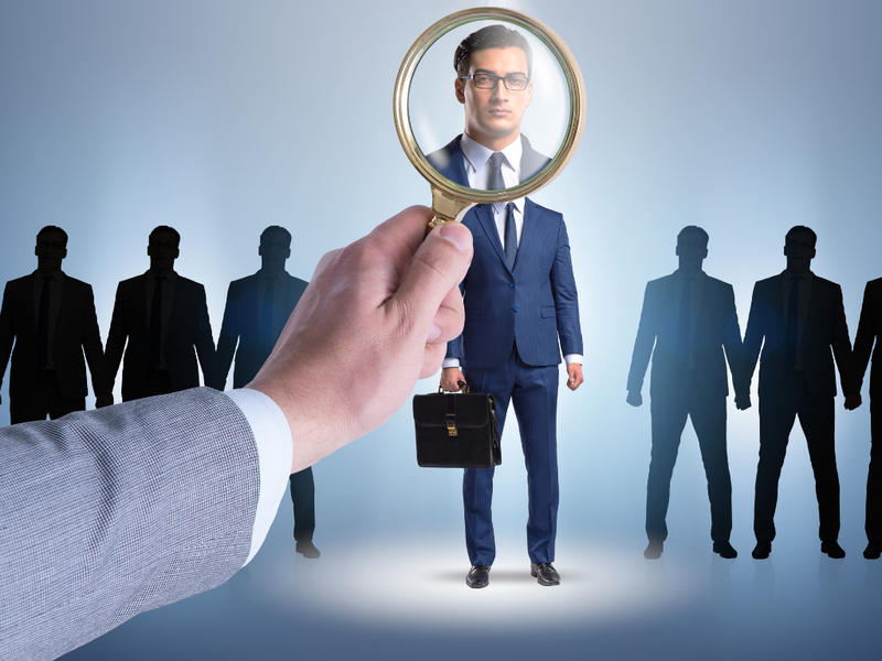 man looking through a magnifier